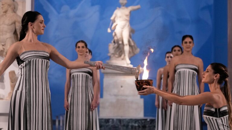 Olympic flame begins journey to Milan Cortina Winter Games amid bad weather